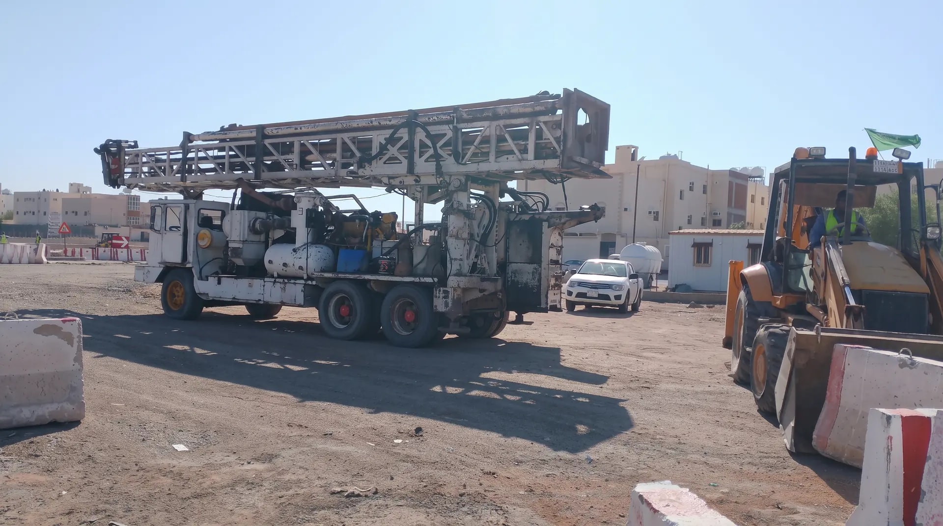 Heavy drilling rig in a protected work zone on the irrigation networks and wells project