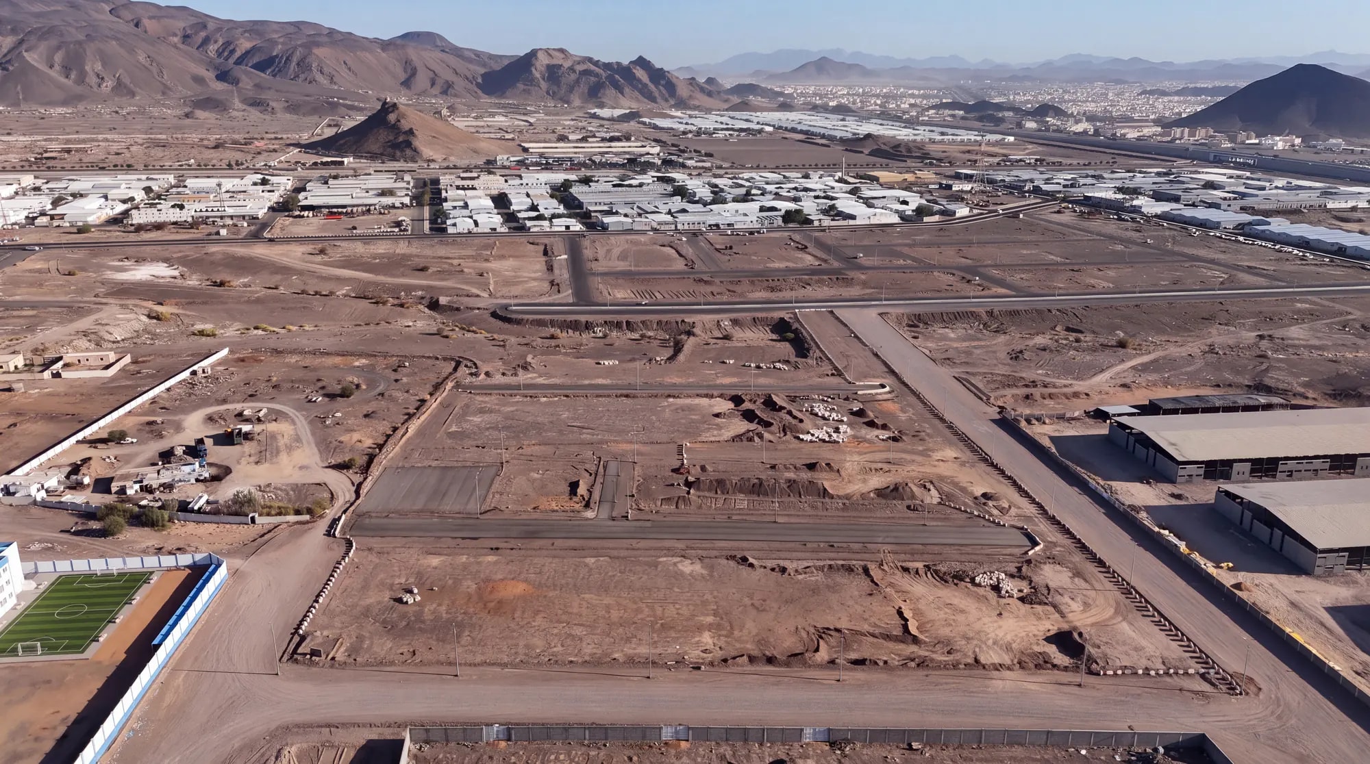 Wide aerial view of roadworks and land preparation within one of the delivered private developments